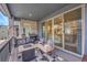 Inviting covered patio with outdoor seating, a grill, and sliding glass doors to the interior at 15794 W Girard Ave, Morrison, CO 80465