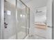 Modern tiled shower showcasing a built-in bench and a glass enclosure next to primary bedroom at 15794 W Girard Ave, Morrison, CO 80465
