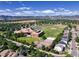 Neighborhood aerial view showcasing a local school, residential streets, and scenic mountain views at 7054 S Flower Ct, Littleton, CO 80128