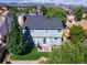 Backyard featuring a lush green lawn, patio area with outdoor seating, and mountain views at 7054 S Flower Ct, Littleton, CO 80128