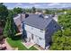 The backyard features a patio area with outdoor seating, lush lawn, and partial fencing at 7054 S Flower Ct, Littleton, CO 80128