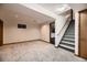 Unfinished basement with carpet, stairs and doorway ready for customization at 7054 S Flower Ct, Littleton, CO 80128