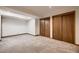 Carpeted bonus room with built-in closets perfect for storage or a rec area at 7054 S Flower Ct, Littleton, CO 80128