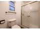Full bathroom showcasing a glass-enclosed shower and modern fixtures at 7054 S Flower Ct, Littleton, CO 80128