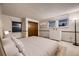 Comfortable bedroom features a neutral color palette, soft carpet, and natural light at 7054 S Flower Ct, Littleton, CO 80128