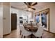 Open dining area view to kitchen with stainless appliances, granite countertops, and dining set at 7054 S Flower Ct, Littleton, CO 80128