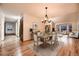 Dining area featuring hardwood floors, modern lighting, and a view into the home's living space at 7054 S Flower Ct, Littleton, CO 80128