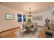 Well-lit dining area featuring hardwood floors, modern lighting, and views of the home's exterior at 7054 S Flower Ct, Littleton, CO 80128