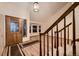 Inviting entryway featuring hardwood floors, a staircase, and a view of the home's bay window at 7054 S Flower Ct, Littleton, CO 80128