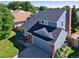 Charming two-story home with a well-maintained lawn, beautiful garden bed, and attached garage at 7054 S Flower Ct, Littleton, CO 80128