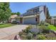 Charming two-story home with blue siding, brick accents, mature trees, and a well-manicured lawn at 7054 S Flower Ct, Littleton, CO 80128