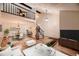 Open-concept living area with hardwood floors, a dining area, and a second-floor balcony at 7054 S Flower Ct, Littleton, CO 80128