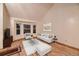 Bright living room featuring hardwood floors, bay windows, neutral furnishings, and a decorative rug at 7054 S Flower Ct, Littleton, CO 80128