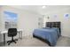 Bright bedroom showcases a large window, a dark wood frame bed, and a workspace for studying or working at 4108 N Quatar Ct, Aurora, CO 80019