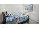 Comfortable bedroom features a twin bed, large window, and ample natural light at 4108 N Quatar Ct, Aurora, CO 80019