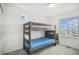 Bedroom features a bunk bed, natural light, and carpeting at 4108 N Quatar Ct, Aurora, CO 80019
