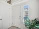 Clean entryway with natural light from sidelight, showcasing a light-colored floor and access to rooms at 4108 N Quatar Ct, Aurora, CO 80019