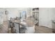 Bright kitchen boasts a large island with granite countertops, stainless steel appliances, and wood plank flooring at 4108 N Quatar Ct, Aurora, CO 80019