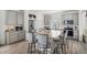 Charming kitchen features stainless steel appliances, granite countertops, gray cabinets, and a large central island at 4108 N Quatar Ct, Aurora, CO 80019