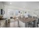 Open-concept kitchen and living area with a granite island, modern appliances, and comfortable seating at 4108 N Quatar Ct, Aurora, CO 80019
