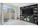 Bright living room with an entertainment center and sliding door access to the outside at 4108 N Quatar Ct, Aurora, CO 80019