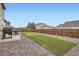 Fenced backyard with a lawn area, ideal for pets and outdoor activities at 56579 E 23Rd Pl, Strasburg, CO 80136