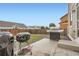 Backyard with a concrete patio and a gas grill, perfect for outdoor cooking and entertaining at 56579 E 23Rd Pl, Strasburg, CO 80136
