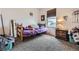 Cozy bedroom with natural light, neutral walls, comfortable carpeting, and furniture at 56579 E 23Rd Pl, Strasburg, CO 80136