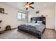 Bedroom with ceiling fan, carpeted floor and ample natural light at 56579 E 23Rd Pl, Strasburg, CO 80136