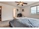 Bedroom with ceiling fan, carpeted floor, closet and ensuite bathroom at 56579 E 23Rd Pl, Strasburg, CO 80136