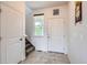Bright foyer featuring tile flooring, a coat closet, and a staircase leading to the upper level at 56579 E 23Rd Pl, Strasburg, CO 80136