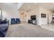 Open-concept living room featuring neutral carpet, and seamless transition to the tiled entryway at 56579 E 23Rd Pl, Strasburg, CO 80136