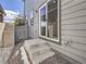 Rear exterior of home with concrete patio, sliding door and landscaping at 4773 Kittredge St, Denver, CO 80239