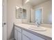 Modern bathroom vanity with a sleek countertop, white cabinetry, and a stylish mirror at 4773 Kittredge St, Denver, CO 80239