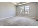 An empty bedroom featuring plush carpeting, two windows, and neutral paint at 4773 Kittredge St, Denver, CO 80239