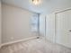 A bedroom featuring plush carpet flooring, a window, and a double-door closet at 4773 Kittredge St, Denver, CO 80239