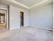 A cozy bedroom with plush carpeting, a tray ceiling, and a walk-in closet at 4773 Kittredge St, Denver, CO 80239