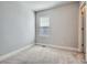 A bedroom featuring plush carpet flooring and a window with blinds at 4773 Kittredge St, Denver, CO 80239