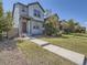 Charming two-story home with landscaped front yard, sidewalk and covered entry at 4773 Kittredge St, Denver, CO 80239