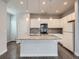Bright, modern kitchen with stainless appliances, granite counters and large island at 4773 Kittredge St, Denver, CO 80239