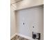 Functional laundry room with shelf, utility hookups, and modern vinyl flooring at 4773 Kittredge St, Denver, CO 80239