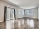 Large living room featuring hardwood floors, multiple windows, and sliding glass door at 4773 Kittredge St, Denver, CO 80239