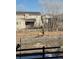 Backyard view with large Elk roaming near a tan two-story house with wood fence at 303 Rogers Ct, Castle Rock, CO 80104