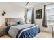Cozy bedroom with a large bed, neutral tones, and natural light from two windows at 303 Rogers Ct, Castle Rock, CO 80104