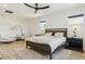 Modern bedroom featuring a ceiling fan, light wood floors, and comfortable seating area at 303 Rogers Ct, Castle Rock, CO 80104
