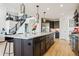 Open concept kitchen featuring a large island with seating, pendant lighting, and stainless steel appliances at 303 Rogers Ct, Castle Rock, CO 80104