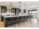 Open concept kitchen featuring a large island with seating, pendant lighting, and stainless steel appliances at 303 Rogers Ct, Castle Rock, CO 80104