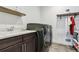 Well-equipped laundry room with modern washer and dryer and ample counter space at 303 Rogers Ct, Castle Rock, CO 80104