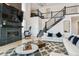 Bright living room featuring a fireplace, large television, and modern staircase at 303 Rogers Ct, Castle Rock, CO 80104
