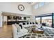 Bright, open-concept living room featuring modern furniture, a large sectional sofa, and access to the backyard at 303 Rogers Ct, Castle Rock, CO 80104